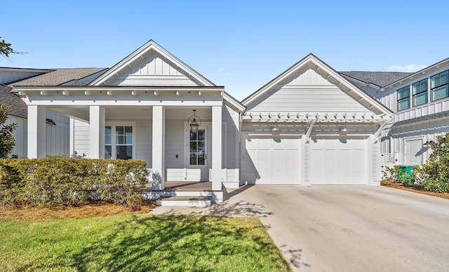 view of front of house with board and batten siding, concrete driveway, a garage, covered porch, and a shingled roof