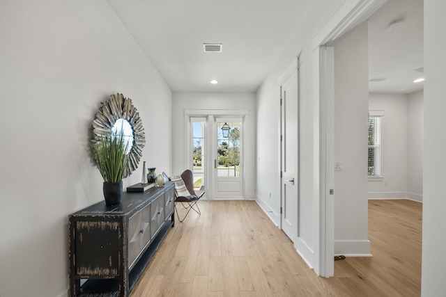 doorway with light wood finished floors, plenty of natural light, baseboards, and recessed lighting