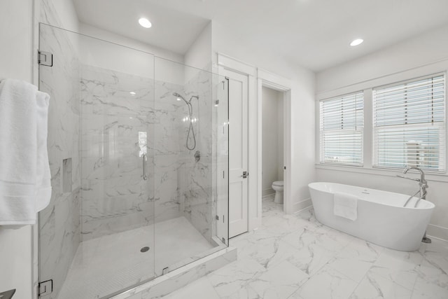 bathroom with recessed lighting, a marble finish shower, a freestanding tub, baseboards, and toilet