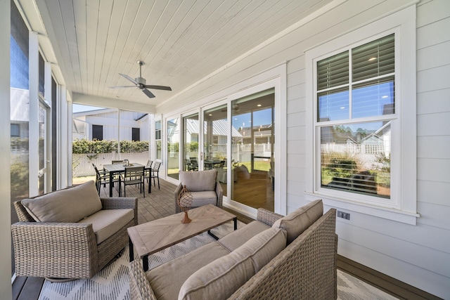 sunroom / solarium featuring outdoor dining area, ceiling fan, and outdoor lounge area