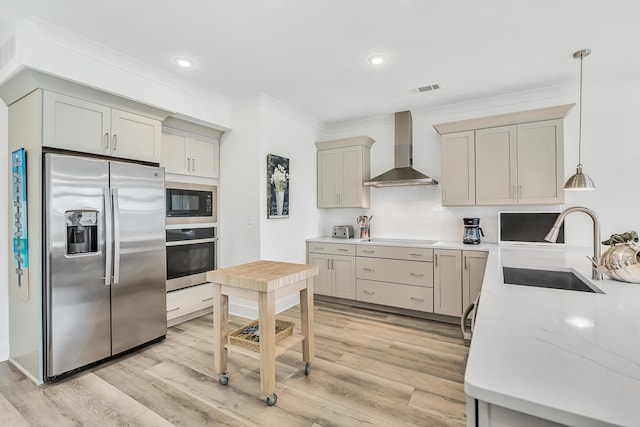 179 S County Highway 393 Unit 445, Santa Rosa Beach, FL 32459 - kitchen with stainless steel appliances, wall chimney exhaust hood, a sink, light countertops, and light wood-type flooring