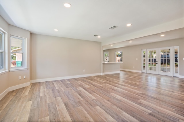 1411 28th St, Niceville, FL 32578 - empty room with recessed lighting, light wood finished floors, french doors, baseboards, and a sink