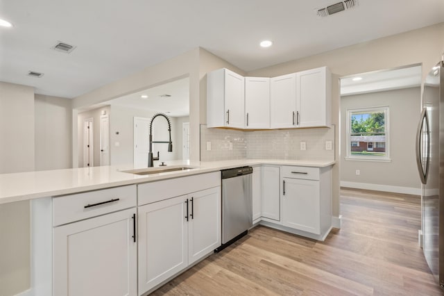 1411 28th St, Niceville, FL 32578 - kitchen with a sink, appliances with stainless steel finishes, light countertops, light wood finished floors, and recessed lighting