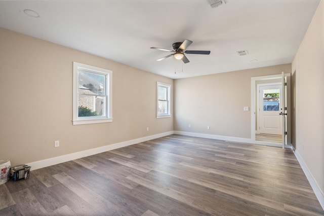 1411 28th St, Niceville, FL 32578 - unfurnished room featuring plenty of natural light, ceiling fan, dark wood-style flooring, and baseboards