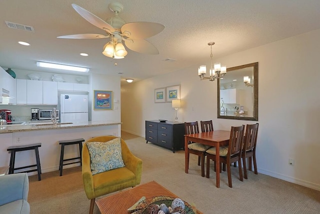 2606 Scenic Gulf Dr Unit 4108, Miramar Beach, FL 32550 - dining room featuring light colored carpet, a ceiling fan, a chandelier, baseboards, and recessed lighting