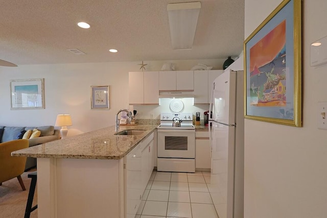 2606 Scenic Gulf Dr Unit 4108, Miramar Beach, FL 32550 - kitchen featuring white appliances, a sink, a peninsula, white cabinets, and under cabinet range hood
