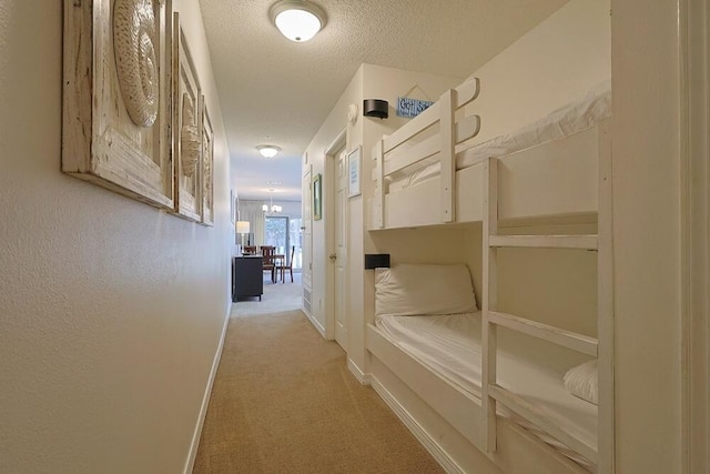 2606 Scenic Gulf Dr Unit 4108, Miramar Beach, FL 32550 - corridor featuring light carpet, a textured ceiling, and baseboards