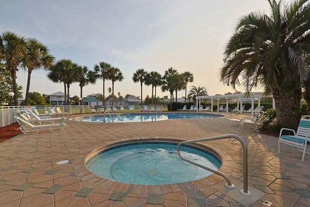 2606 Scenic Gulf Dr Unit 4108, Miramar Beach, FL 32550 - pool at dusk with a pergola, a patio, a hot tub, and a community pool