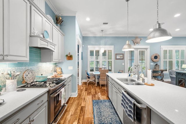 728 Breakers St, Watersound, FL 32461 - kitchen with a sink, appliances with stainless steel finishes, light countertops, ornamental molding, and backsplash