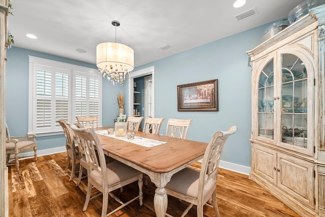 728 Breakers St, Watersound, FL 32461 - dining area with light wood-style floors, a chandelier, baseboards, and recessed lighting