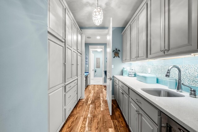 728 Breakers St, Watersound, FL 32461 - kitchen with gray cabinets, a sink, tasteful backsplash, wood finished floors, and pendant lighting