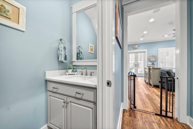 728 Breakers St, Watersound, FL 32461 - bathroom with wood finished floors, vanity, recessed lighting, french doors, and baseboards