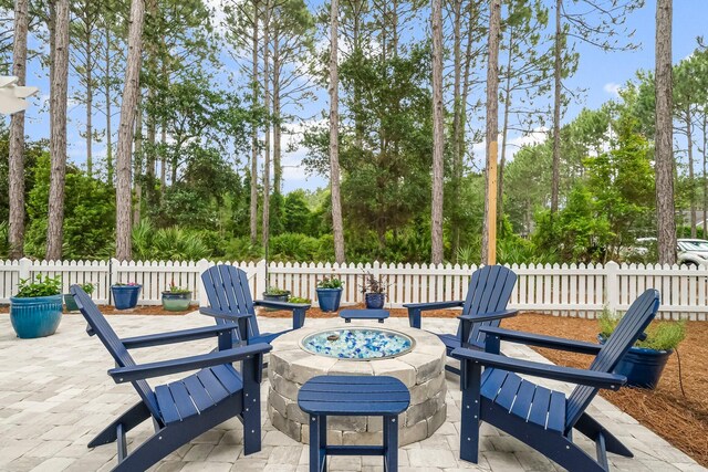 728 Breakers St, Watersound, FL 32461 - view of patio featuring a fire pit and view of wooded area