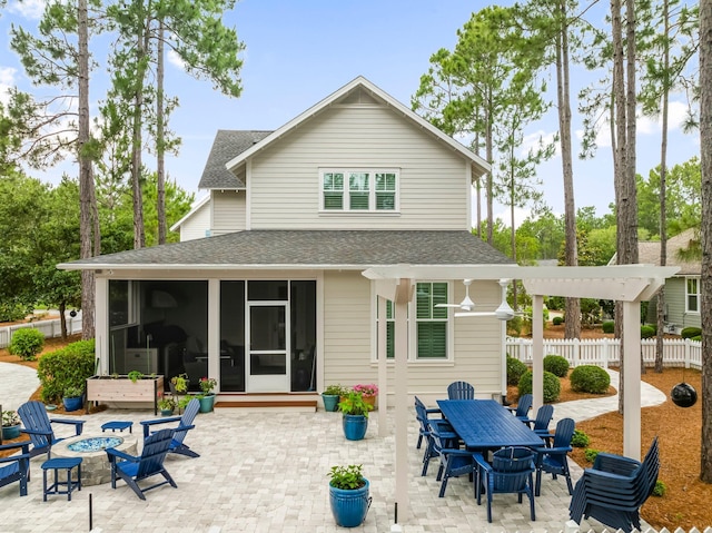 728 Breakers St, Watersound, FL 32461 - back of property featuring a sunroom, an outdoor fire pit, roof with shingles, a patio, and outdoor dining space