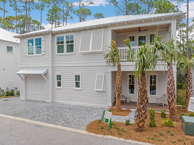 26 Silver Maple Dr, Inlet Beach, FL 32461 - view of front of property with covered porch, metal roof, a balcony, an attached garage, and a ceiling fan