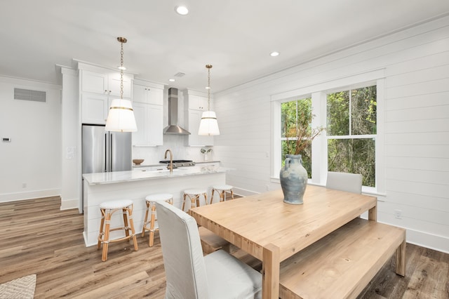 26 Silver Maple Dr, Inlet Beach, FL 32461 - dining area with light wood finished floors, baseboards, recessed lighting, crown molding, and wooden walls