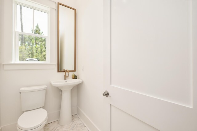 26 Silver Maple Dr, Inlet Beach, FL 32461 - half bathroom with baseboards, toilet, and marble look tile flooring