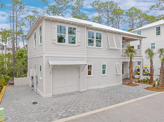 26 Silver Maple Dr, Inlet Beach, FL 32461 - view of front of house featuring metal roof, an attached garage, driveway, and a balcony