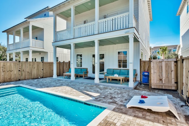 246 Driftwood Rd, Miramar Beach, FL 32550 - back of house featuring an outdoor hangout area, board and batten siding, a balcony, and a patio area