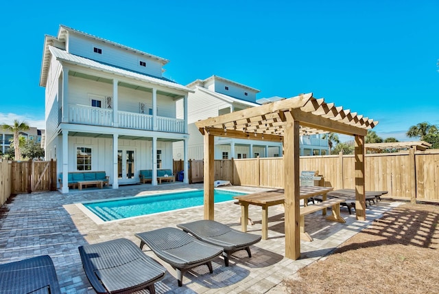 246 Driftwood Rd, Miramar Beach, FL 32550 - rear view of house featuring french doors, board and batten siding, a pergola, a fenced backyard, and a balcony