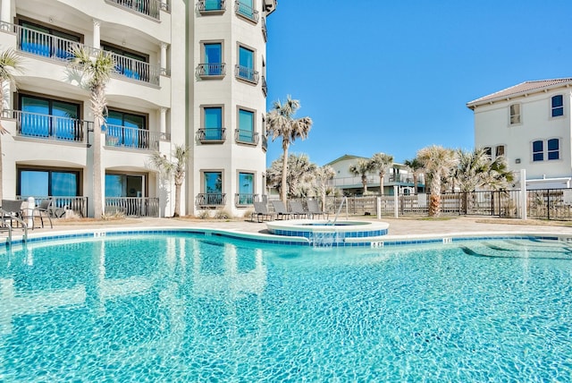 134 Norwood Dr Ph 3, Miramar Beach, FL 32550 - view of swimming pool with fence, a pool with connected hot tub, and a patio area