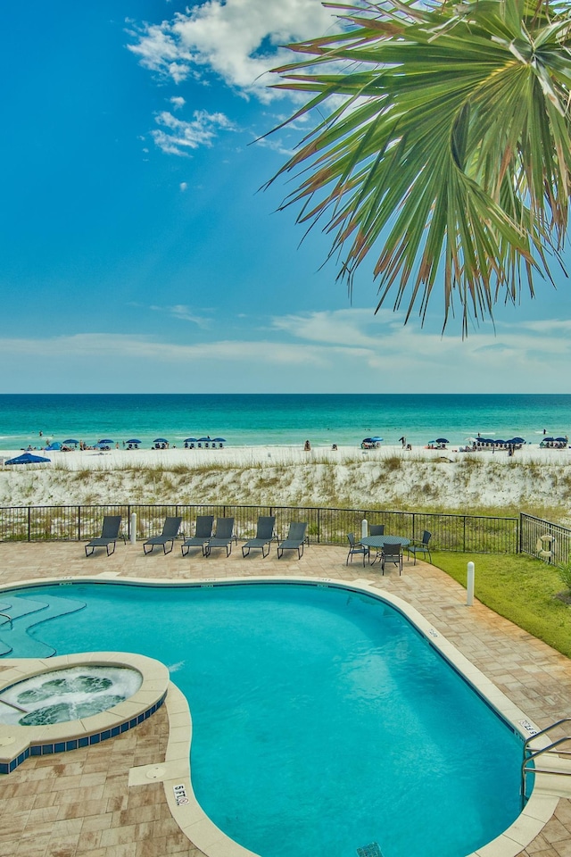 134 Norwood Dr Ph 3, Miramar Beach, FL 32550 - community pool with view of water and beach, fence, a patio, and a hot tub