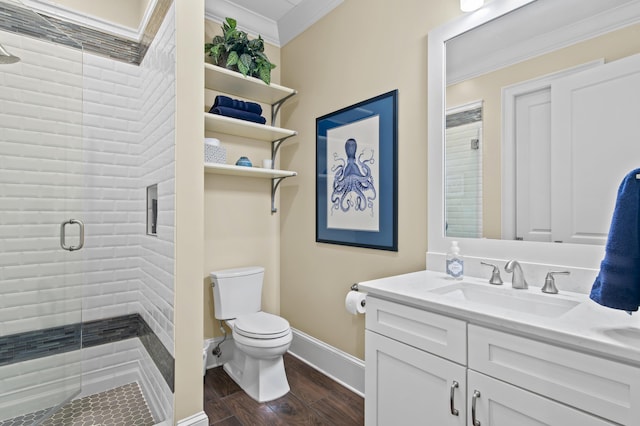 134 Norwood Dr Ph 3, Miramar Beach, FL 32550 - bathroom with ornamental molding, a stall shower, toilet, vanity, and wood finished floors