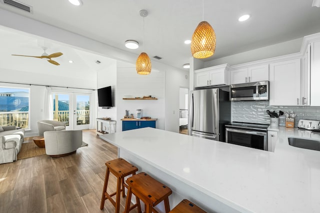 216 E Park Place Ave, Inlet Beach, FL 32461 - kitchen featuring stainless steel appliances, open floor plan, vaulted ceiling, light countertops, and a peninsula