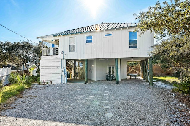 216 E Park Place Ave, Inlet Beach, FL 32461 - view of front of house with a carport, stairs, driveway, metal roof, and a standing seam roof