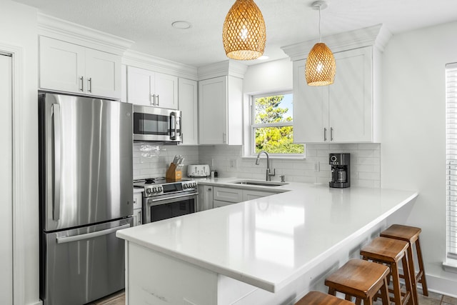 216 E Park Place Ave, Inlet Beach, FL 32461 - kitchen with appliances with stainless steel finishes, a sink, a kitchen breakfast bar, and decorative backsplash