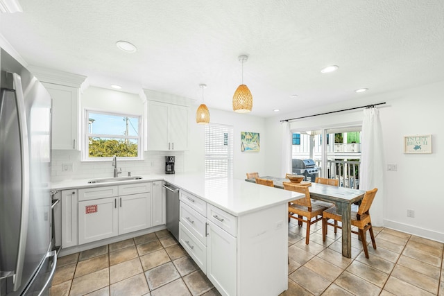 216 E Park Place Ave, Inlet Beach, FL 32461 - kitchen with stainless steel appliances, a sink, a peninsula, tasteful backsplash, and light countertops