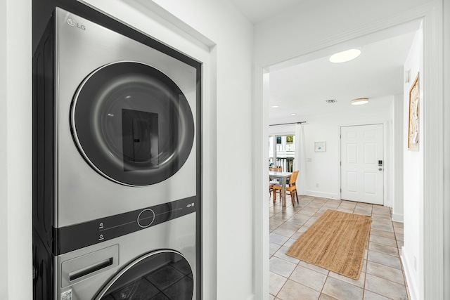 216 E Park Place Ave, Inlet Beach, FL 32461 - laundry area featuring stacked washer / drying machine, light tile patterned floors, and baseboards