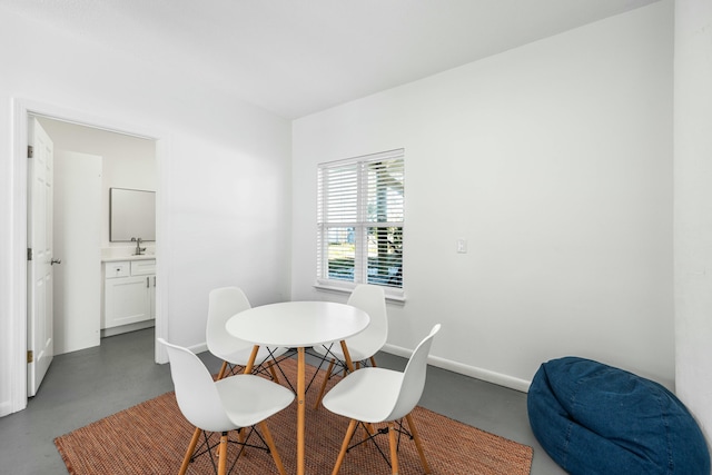 216 E Park Place Ave, Inlet Beach, FL 32461 - dining area featuring concrete flooring and baseboards