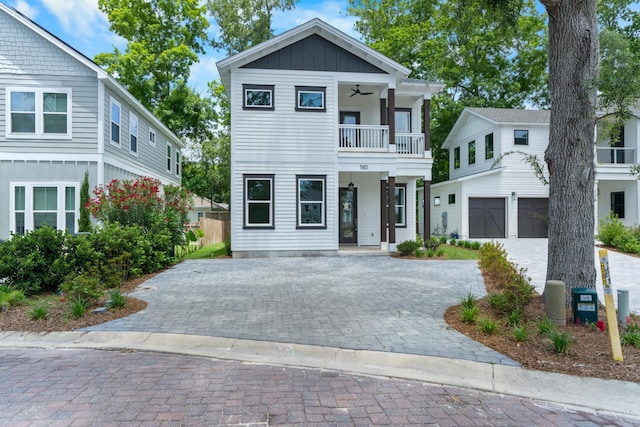 180 Rearden Way, Santa Rosa Beach, FL 32459 - view of front of house with a balcony, decorative driveway, a ceiling fan, board and batten siding, and an attached garage