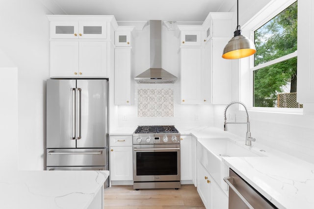 180 Rearden Way, Santa Rosa Beach, FL 32459 - kitchen featuring high quality appliances, wall chimney range hood, white cabinets, and decorative backsplash