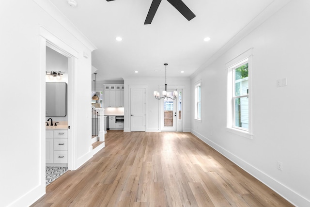 180 Rearden Way, Santa Rosa Beach, FL 32459 - unfurnished living room featuring light wood-style flooring, a ceiling fan, a chandelier, baseboards, and recessed lighting