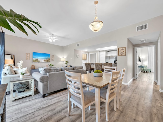 4205 Indian Bayou Trl Unit 10, Destin, FL 32541 - dining room featuring light wood-style floors, ceiling fan, and baseboards