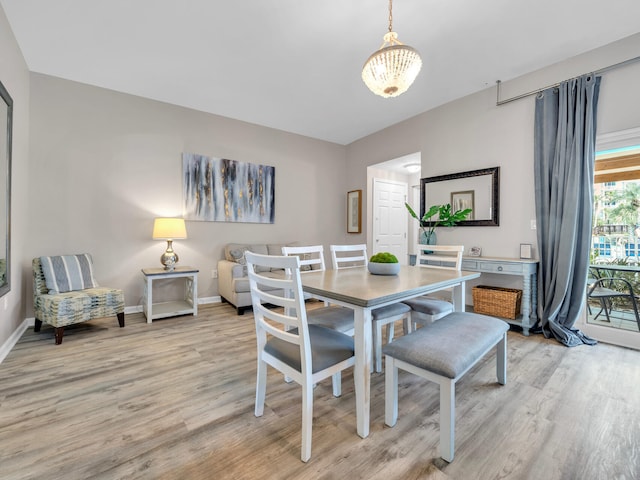 4205 Indian Bayou Trl Unit 10, Destin, FL 32541 - dining space with light wood-style floors, baseboards, and a chandelier