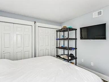 308 Miracle Strip Pkwy Unit 1C, Fort Walton Beach, FL 32548 - bedroom with multiple closets and baseboards