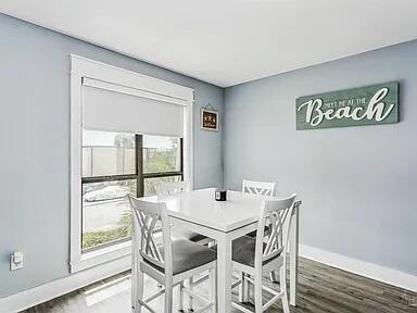 308 Miracle Strip Pkwy Unit 1C, Fort Walton Beach, FL 32548 - dining space with baseboards and wood finished floors