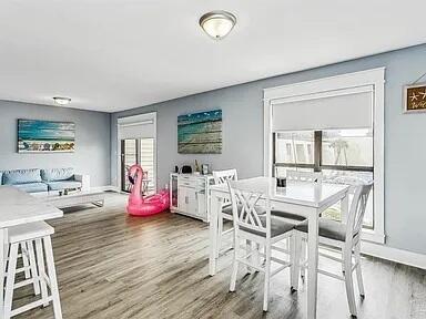 308 Miracle Strip Pkwy Unit 1C, Fort Walton Beach, FL 32548 - dining area featuring wood finished floors and baseboards
