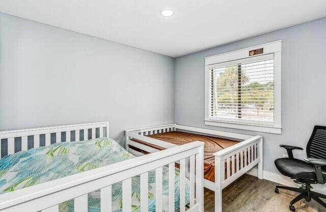 308 Miracle Strip Pkwy Unit 1C, Fort Walton Beach, FL 32548 - bedroom with wood finished floors, baseboards, and recessed lighting