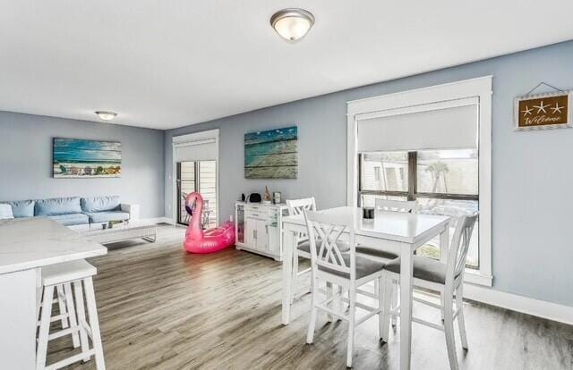 308 Miracle Strip Pkwy Unit 1C, Fort Walton Beach, FL 32548 - dining room featuring light wood finished floors and baseboards