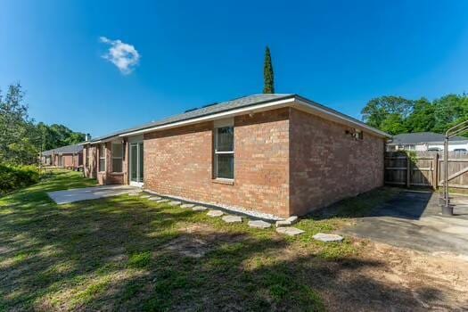 430 Hatchee Dr, Crestview, FL 32536 - view of side of home with a patio area and brick siding