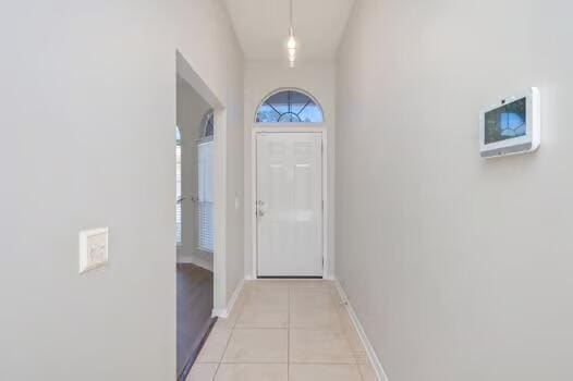 430 Hatchee Dr, Crestview, FL 32536 - doorway to outside featuring light tile patterned flooring and baseboards