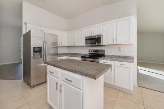 430 Hatchee Dr, Crestview, FL 32536 - kitchen featuring appliances with stainless steel finishes, white cabinetry, and light tile patterned floors