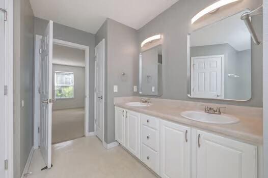 430 Hatchee Dr, Crestview, FL 32536 - bathroom featuring double vanity and baseboards