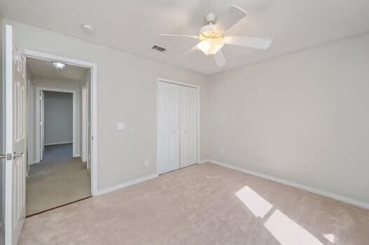 430 Hatchee Dr, Crestview, FL 32536 - unfurnished bedroom featuring carpet, a closet, baseboards, and a ceiling fan