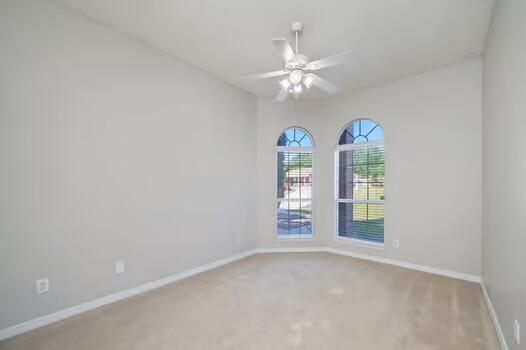 430 Hatchee Dr, Crestview, FL 32536 - spare room featuring carpet flooring, baseboards, and a ceiling fan