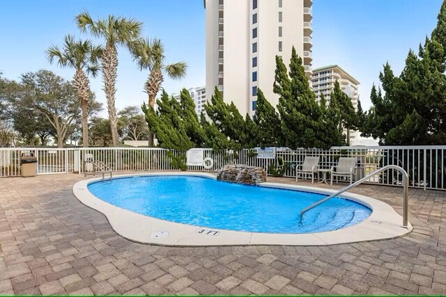 15100 Emerald Coast Pkwy Unit Ph4, Destin, FL 32541 - community pool with a patio area